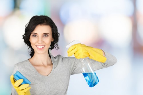 Cleaner working on upper-floor windows in Battersea